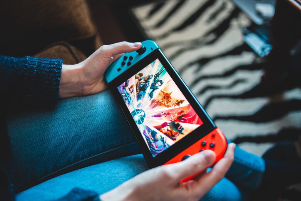 The image showcases a person playing a nintendo switch, representating the growing popularity of play to earn games