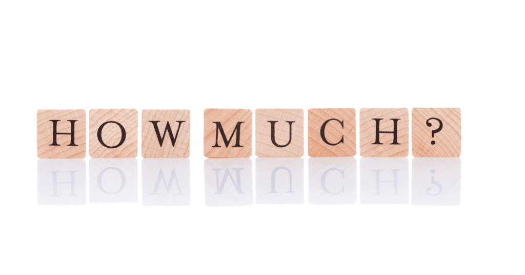 Wooden blocks spelling out "HOW MUCH?" on a reflective white surface.