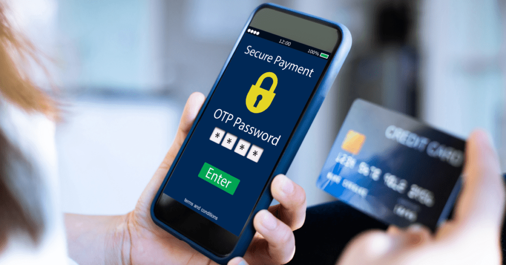 Person holding a smartphone displaying a secure payment screen with an OTP password prompt, alongside a credit card.
